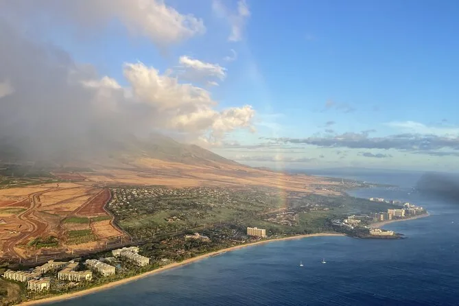 Resort beaches along the West Maui coast with a rainbow over the mountains
